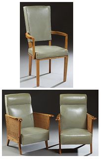 Group of Three French Mid-Century Modern Carved Oak Leather Armchairs, 20th c., consisting of a pair with canted backs over curved double caned arms, 