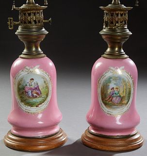 Pair of French Brass and Porcelain Carcel Style Lamps, 20th c., the baluster sides with reserves of courting couples, on a stepped circular wood base,