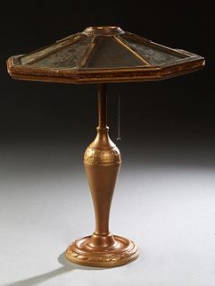 American Gilt Spelter Table Lamp, c. 1920, with a wooden eight parchment paneled shade, on a baluster relief support to a stepped circular base, H.- 2