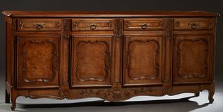 French Louis XV Style Carved Elm and Cherry Sideboard, 20th c., the stepped parquetry inlaid rounded edge and corner top over four frieze drawers and 