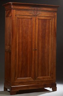French Provincial Louis Philippe Carved Walnut Armoire, c. 1860, the rounded corner ogee crown over double paneled doors, on a plinth base on bracket 
