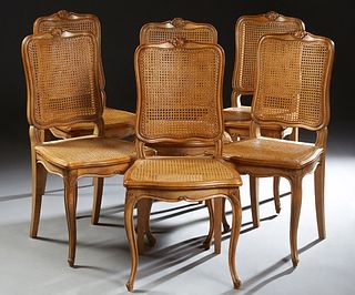 Set of Six French Louis XVI Style Carved Beech Dining Chairs, 20th c. the arched crest rails with shell carving over canted caned backs and stepped bo