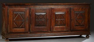 French Provincial Louis XIII Style Carved Walnut Sideboard, 19th c., the rectangular top over four fielded panel cupboard doors with incised "X" decor
