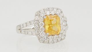 Lady's Platinum Dinner Ring, with a cushion cut 2.09 yellow sapphire, atop a conforming double graduated concentric border of round diamonds, the spli