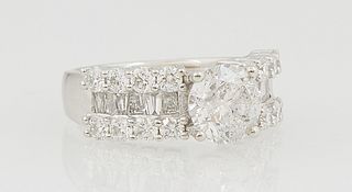 Lady's Platinum Dinner Ring, with a central 2.02 ct. round diamond, flanked by shoulders with a central row of baguette diamonds, within borders of ro