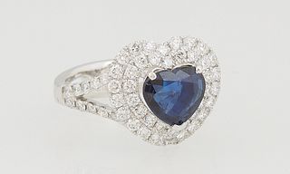 Lady's Platinum Dinner Ring, with a heart shaped 1.93 ct. blue sapphire, atop a conforming double graduated concentric border of round white diamonds,