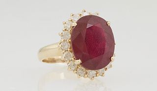 Lady's 14K Yellow Gold Dinner Ring, with a 13.31 carat oval ruby atop a border of diamond "points," total diamond wt.- 1.1 cts, Size 6 1/4, with appra
