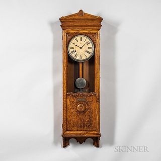 Bundy Time Recorder Wall Clock, Binghamton, New York, oak case with full-length door, upper portion glazed, lower wood panel with folia