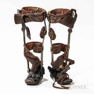 Set of Early Child's Leg Braces, steel framework with leather-covered braces, rotating knee joint, leather shoes measure 5 1/2, ht. 12