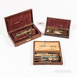 Three Cased 19th Century Enema Sets, England, velvet-lined fitted mahogany cases with brass and pewter instruments, turned wood handles