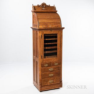 The Harvard Co. Quarter-sawn Oak Dental Cabinet, Canton, Ohio, c. 1890, roll-top upper section above hinged beveled glass midsection do