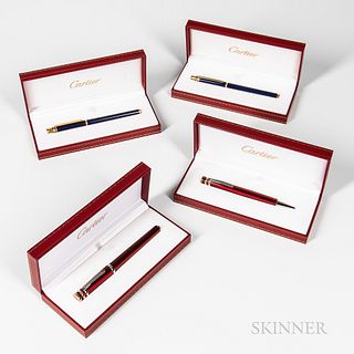 Two Cartier Fountain and Rollerball Pen Sets, "Trinity De" in red lacquer, and Stylo "Must de" in blue lacquer, all with inner, outer b