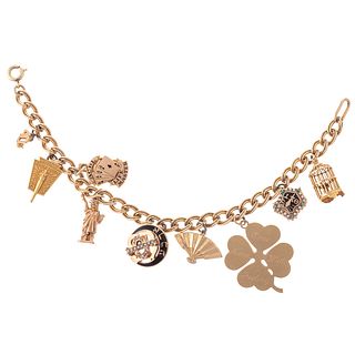 A 10K Charm Bracelet with Nine Charms in Gold