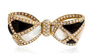 * A Yellow Gold, Diamond, Mother-of-Pearl and Onyx Bow Brooch, 35.90 dwts.