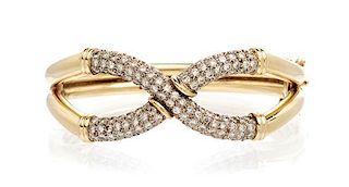 * A Two Tone Gold and Diamond Criss Cross Bangle Bracelet, 38.20 dwts.
