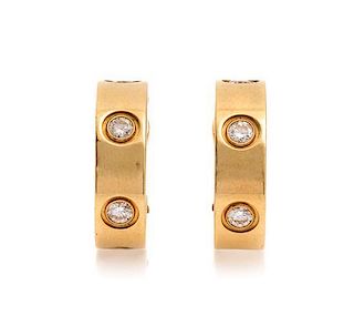A Pair of 18 Karat Yellow Gold and Diamond LOVE Earclips, Cartier, 7.60 dwts.