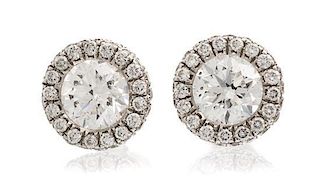 * A Pair of 14 Karat White Gold and Diamond Studs, 0.80 dwts.