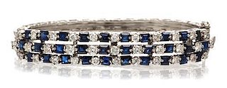 * A 14 Karat White Gold, Diamond and Sapphire Bangle Bracelet, 36.00 dwts.