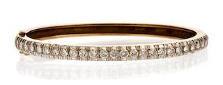 A 14 Karat Yellow Gold and Diamond Bangle Bracelet, 12.30 dwts.