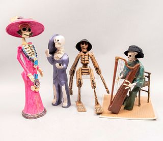 Lote de 4 figuras decorativas. México. Siglo XX. Elaborados en papel maché y barro policromado. Consta de: catrina, catrín, otros.