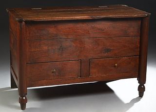 French Provincial Carved Oak Coffer, 19th c., the rounded corner hinged top over open storage and two lower front doors on cylindrical legs with turne