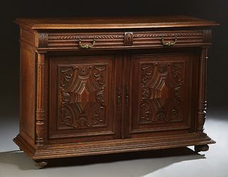 French Provincial Carved Oak Henri II Style Sideboard, c. 1880, the stepped three board rounded edge top over two setback frieze drawers, above setbac