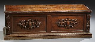 French Provincial Henri II Style Carved Oak Bedding Box, c. 180, the incise carved gadroon edge top over a front panel with applied leaf and nut carvi