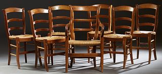 Set of Seven (6 +1) Louis Philippe Carved Cherry Rush Seat Dining Chairs, 19th c., consisting of six ladderback side chairs and one fauteuil, the back