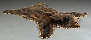 Taxidermied Black Bear Rug, 20th c., on a cloth backing, H.- 79 in., W.- 60 in., D.- 9 in.