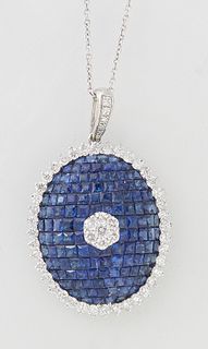 18K White Gold Oval Domed Sapphire Pendant, with a central white round diamond, atop a dome of 132 tiny blue sapphires, within a border of tiny round 