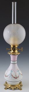 French Bronze and Porcelain Carcel Lamp, 19th c., of baluster form with hand painted floral sides, on a pierced brass base with an etched glass globe 