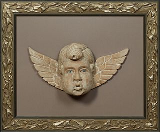 Carved Wood Cherub's Head, 19th c., with blue glass eyes and traces of white paint, presented in a gilt and gesso relief shadow box frame, H.- 8 in., 