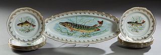 Thirteen Piece French Porcelain Fish Set, 20th c., by Veritable Porcelaine, consisting of twelve plates with scalloped gilt rims around bands of silve