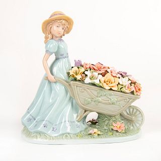 Cosmos Porcelain Figurine, Girl With Barrow Of Flowers