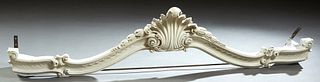 Carved Polychromed Beech Louis XV Style Baldequin, 20th c., with a central shell carving flanked by bellflowers, above an oval serpentine scroll decor