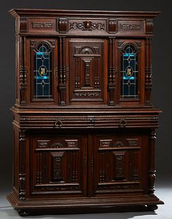 French Carved Oak Henri II Style Carved Oak Sideboard, c. 1880, the stepped crown over a relief carved central cupboard door with relief narrow turned