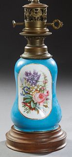 French Porcelain Oil Lamp, 19th c., with floral reserves on both sides, on a blue ground, on a stepped circular wooden base, now electrified, H.- 22 i