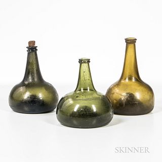 Three Blown Glass Bottles, late 18th century, in shades of green and olive, with tapering necks and bulbous bases with concave bottoms,