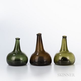 Three Blown Glass Bottles, late 18th century, with tapering necks and bulbous bases with concave bottoms, ht. to 7 3/4 in.