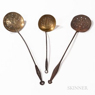 Three Brass and Iron Skimmers, 19th century, two with brass sieves, one with an iron sieve, the longer brass sieve stamped "C.F. PIERCE