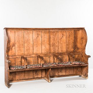 Pine Settle Bench, late 18th/early 19th century, the slightly concave back and shaped sides with overhanging cornice and six scrolled a