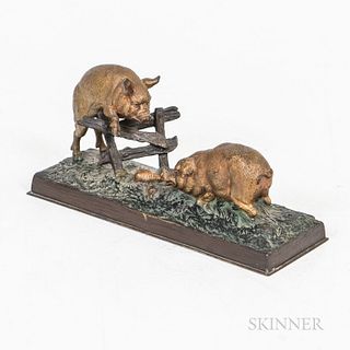 Small Painted Cast Bronze Figure of Two Pigs, probably Continental, 19th century, one jumping a split-rail fence, the other eating vege