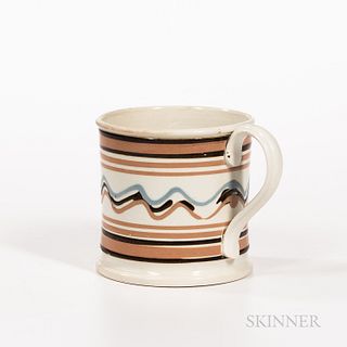 Large Slip-decorated Pearlware Mug, England, early 19th century, with bands of brown and salmon, and wavy lines in blue, brown, and sal