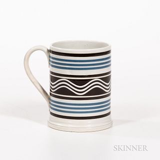 Slip-decorated Pearlware Quart Mug, England, early 19th century, with blue and black banding, the wide central band with wavy lines of