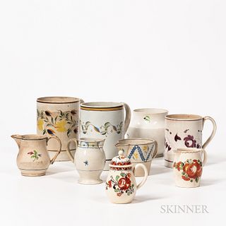 Group of Creamware and Pearlware, England, early 19th century, comprising three mugs, four small pitchers, a sugar (lacking cover), and