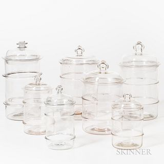 Seven Blown Colorless Glass Food Jars, America, early 19th century, domed tops with knobs, cylindrical bodies with applied colorless ri