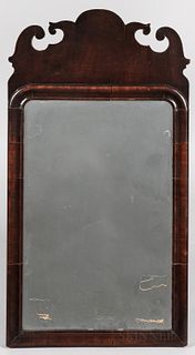 Queen Anne Walnut Veneer Mirror, England, late 18th century, the scrolled crest above a molded veneered frame with rounded upper corner