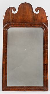 Queen Anne Walnut Veneer Mirror, possibly New England, late 18th century, the scrolled crest above a shaped and molded frame, old repla