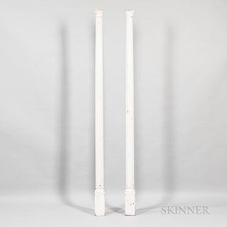 Pair of Carved and White-painted Wooden Columns, 19th century, with flaring capitals, slightly tapering fluted posts, and rectangular b
