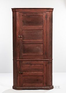 Red-painted Corner Cupboard, early 19th century, the molded cornice above upper and lower paneled doors, each opening to shelves, flank